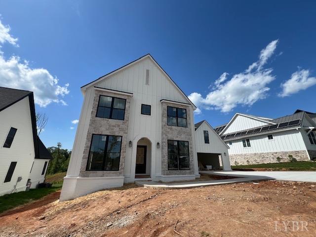 917 Elmwood Ave, Lynchburg, VA 24503 - modern farmhouse featuring board and batten siding, a garage, stone siding, and driveway