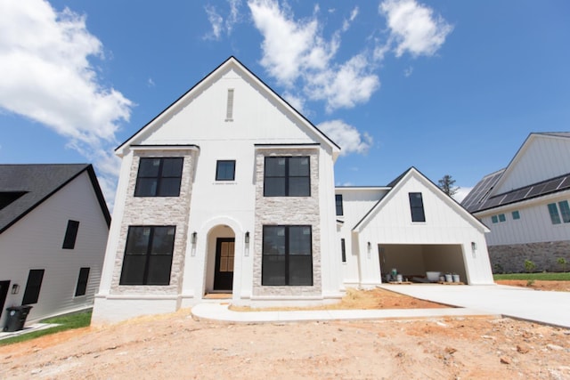 917 Elmwood Ave, Lynchburg, VA 24503 - view of front of house featuring stone siding, concrete driveway, a garage, and board and batten siding