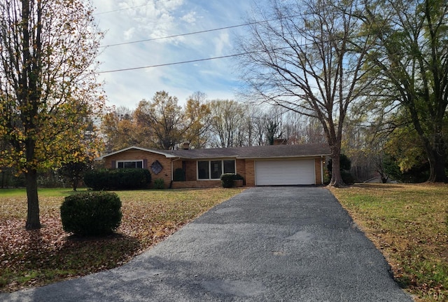 233 Matthews Rd, Appomattox, VA 24522 - ranch-style house with driveway, a chimney, a garage, brick siding, and a front yard