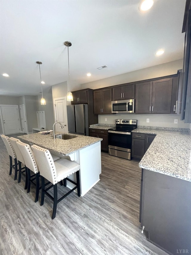 67 Warwick Dr, Lynchburg, VA 24501 - kitchen with a kitchen breakfast bar, pendant lighting, a kitchen island with sink, appliances with stainless steel finishes, and sink
