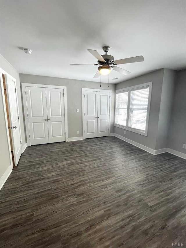 67 Warwick Dr, Lynchburg, VA 24501 - unfurnished bedroom with ceiling fan, two closets, and dark hardwood / wood-style floors