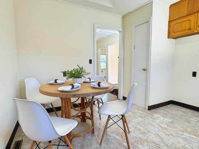 dining area featuring crown molding, visible vents, and baseboards