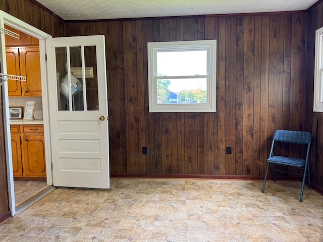 spare room featuring wooden walls and baseboards