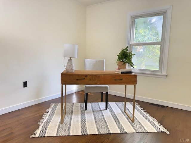 office area featuring visible vents, baseboards, and wood finished floors