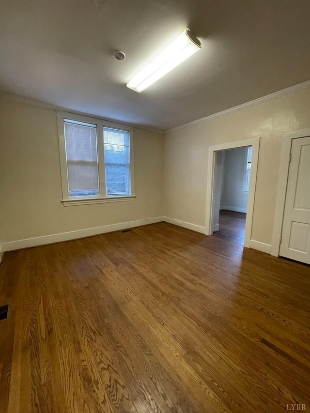 307 Stafford St, Lynchburg, VA 24501 - empty room featuring baseboards, crown molding, wood finished floors, and visible vents