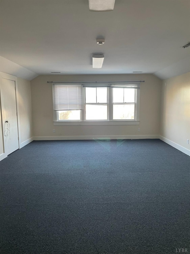 307 Stafford St, Lynchburg, VA 24501 - unfurnished room featuring dark colored carpet, lofted ceiling, baseboards, and plenty of natural light