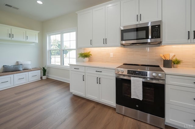 3 Live Oak Dr, Forest, VA 24551 - kitchen with appliances with stainless steel finishes, wood finished floors, baseboards, light countertops, and recessed lighting