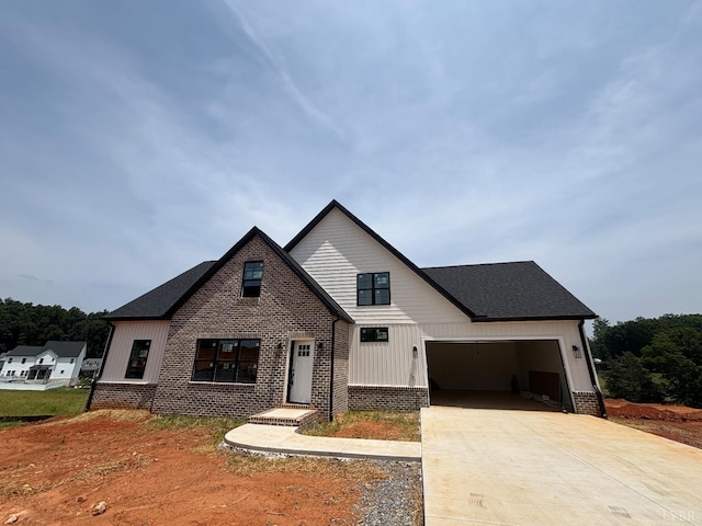 3 Live Oak Dr, Forest, VA 24551 - modern inspired farmhouse with driveway, brick siding, board and batten siding, and an attached garage