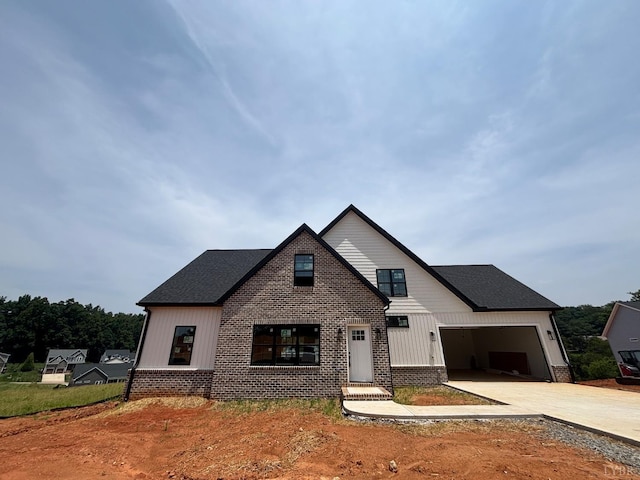 3 Live Oak Dr, Forest, VA 24551 - modern inspired farmhouse with concrete driveway, brick siding, and board and batten siding