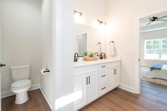 3 Live Oak Dr, Forest, VA 24551 - full bath featuring wood finished floors, double vanity, toilet, baseboards, and ceiling fan