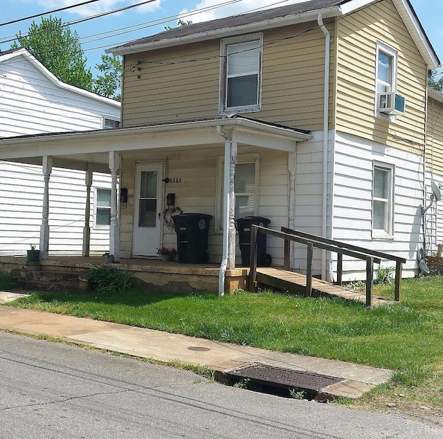 view of front facade featuring a porch and cooling unit