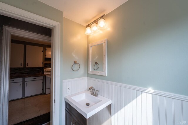 4610 Alabama Ave, Lynchburg, VA 24502 - bathroom with vanity, tile patterned floors, and a wainscoted wall