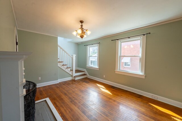 4610 Alabama Ave, Lynchburg, VA 24502 - unfurnished living room featuring hardwood / wood-style flooring, baseboards, a chandelier, ornamental molding, and stairs