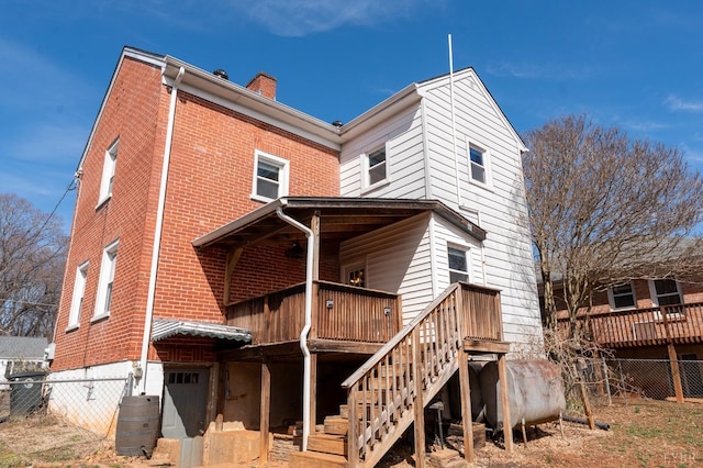 4610 Alabama Ave, Lynchburg, VA 24502 - rear view of property with brick siding, a deck, fence, and a chimney