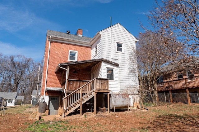 4610 Alabama Ave, Lynchburg, VA 24502 - rear view of property featuring fence, heating fuel, a chimney, brick siding, and stairs