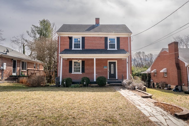4610 Alabama Ave, Lynchburg, VA 24502 - view of front of house featuring a porch, brick siding, a chimney, and a front yard