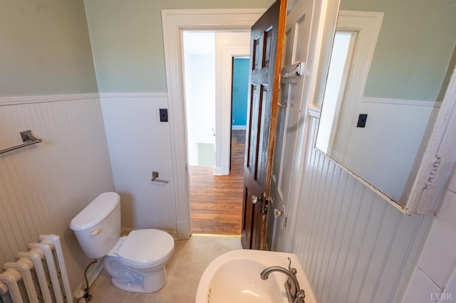 4610 Alabama Ave, Lynchburg, VA 24502 - half bathroom with radiator heating unit, a wainscoted wall, toilet, and a sink