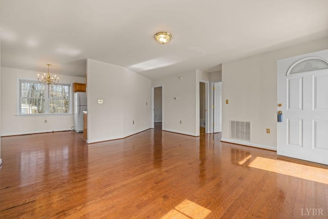 302 Pilot View Rd, Concord, VA 24538 - unfurnished living room featuring a chandelier, baseboards, and wood finished floors