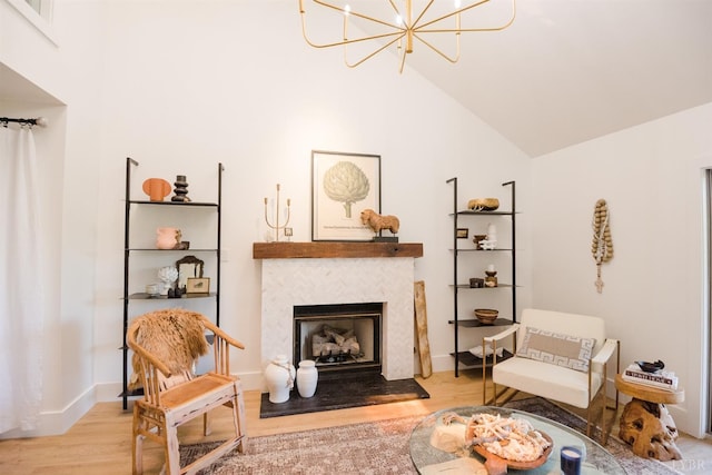 1926 Canterbury Ct Unit 301, Lynchburg, VA 24503 - living area with a notable chandelier, a fireplace with raised hearth, baseboards, wood finished floors, and lofted ceiling