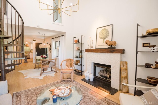 1926 Canterbury Ct Unit 301, Lynchburg, VA 24503 - living area featuring stairway, an inviting chandelier, a glass covered fireplace, and wood finished floors