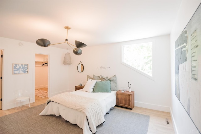 1926 Canterbury Ct Unit 301, Lynchburg, VA 24503 - bedroom with light wood-type flooring, baseboards, a walk in closet, and visible vents