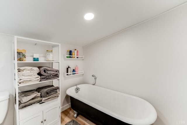 1038 Valencia Dr, Huddleston, VA 24101 - full bath featuring a soaking tub, wood finished floors, and toilet