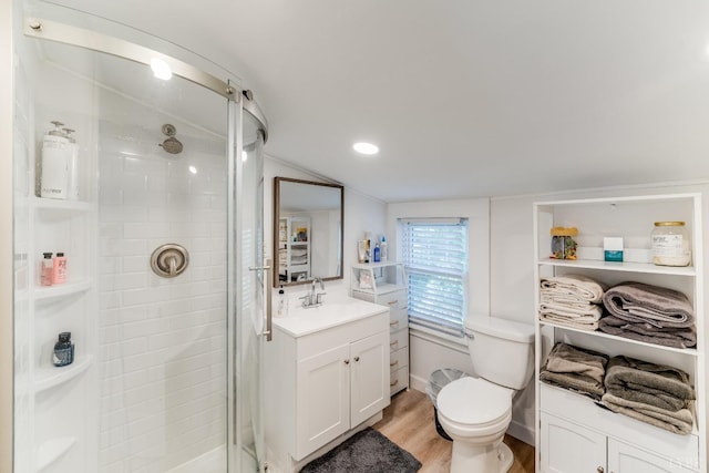 1038 Valencia Dr, Huddleston, VA 24101 - full bathroom with a stall shower, lofted ceiling, wood finished floors, toilet, and vanity