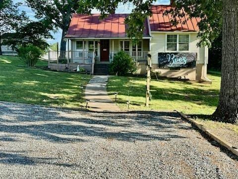 view of front of home with covered porch and a front yard