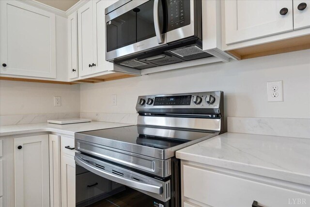 2802 Liberty Chapel Rd, Appomattox, VA 24522 - kitchen featuring stainless steel appliances, white cabinets, and light stone countertops