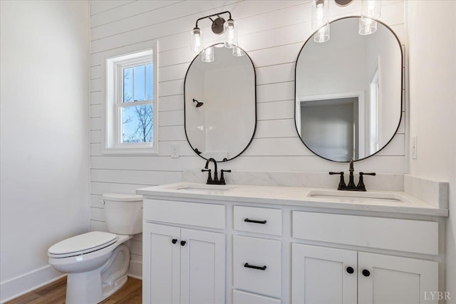 2802 Liberty Chapel Rd, Appomattox, VA 24522 - bathroom with double vanity, toilet, wood finished floors, wooden walls, and baseboards