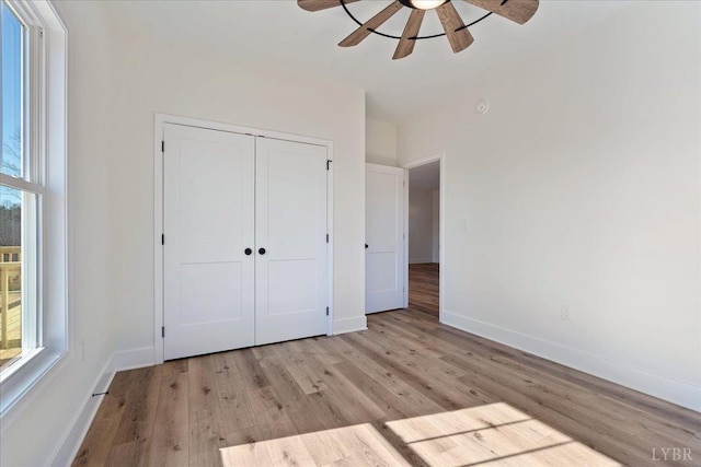 2802 Liberty Chapel Rd, Appomattox, VA 24522 - unfurnished bedroom featuring light wood-style flooring, baseboards, a closet, and a ceiling fan