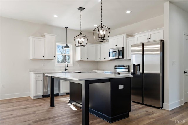 2802 Liberty Chapel Rd, Appomattox, VA 24522 - kitchen featuring stainless steel appliances, a chandelier, a center island, baseboards, and light countertops