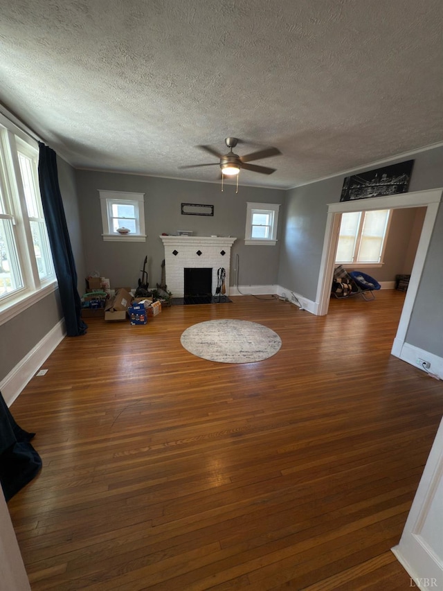 318 Westover Blvd, Lynchburg, VA 24501 - unfurnished living room featuring a fireplace, a textured ceiling, wood finished floors, and a ceiling fan