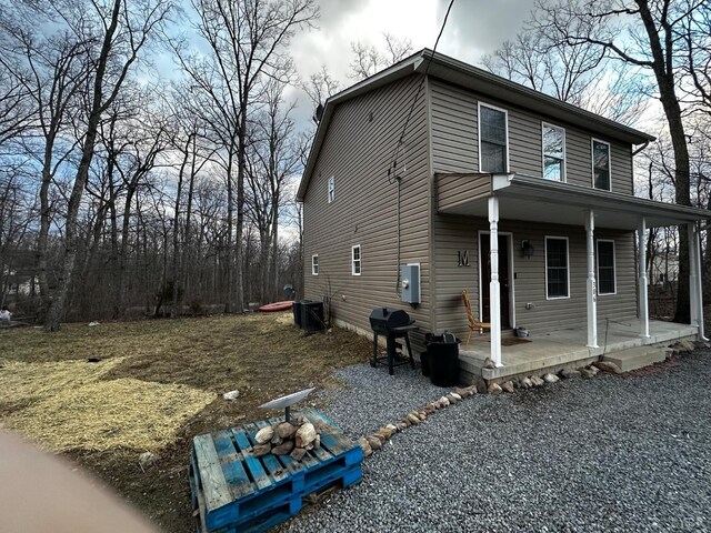 view of front facade featuring central AC unit and covered porch