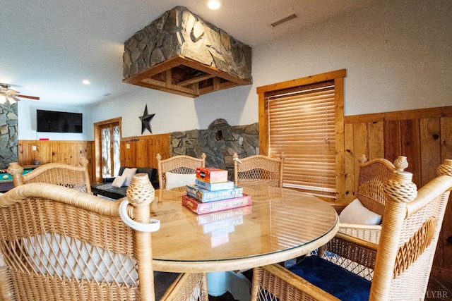 1582 Venturous Trl, Goode, VA 24556 - dining area with ceiling fan, visible vents, wainscoting, and wood walls