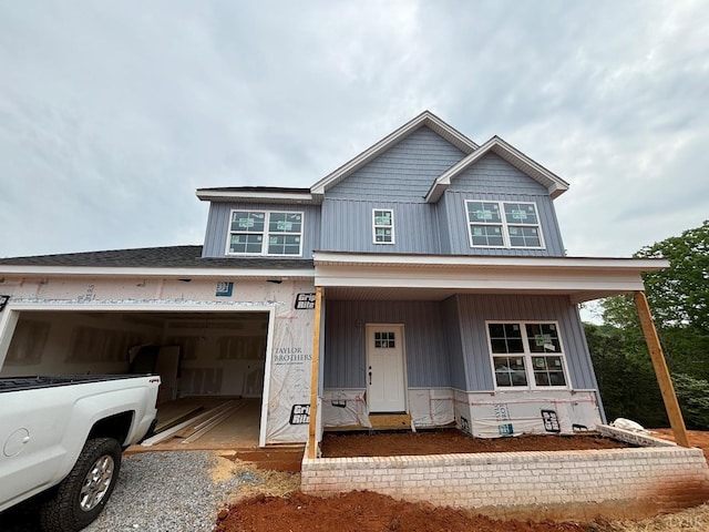property under construction featuring covered porch and an attached garage