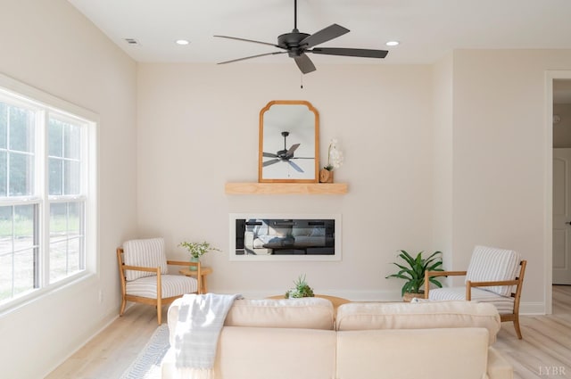 4 Live Oak Dr, Forest, VA 24551 - living area with light wood-type flooring, ceiling fan, a wealth of natural light, and a glass covered fireplace