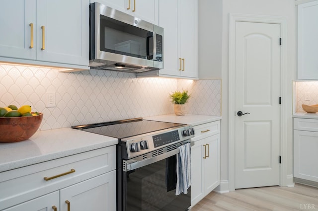 4 Live Oak Dr, Forest, VA 24551 - kitchen with white cabinetry, stainless steel appliances, light wood finished floors, and backsplash