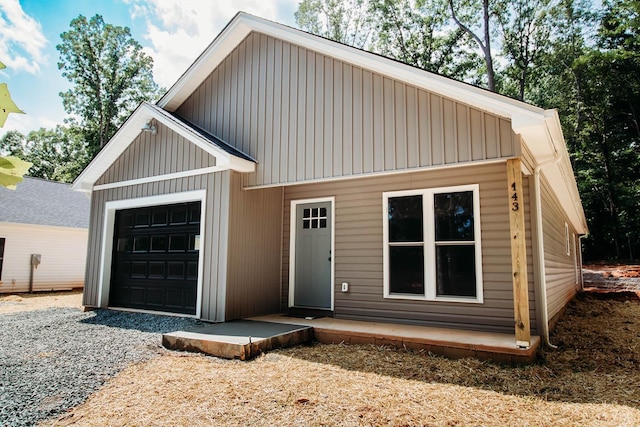 143 Reichard Dr, Madison Heights, VA 24572 - view of front of house featuring board and batten siding and an attached garage