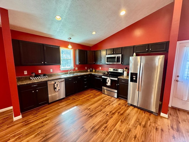 2809 Herbert St, Lynchburg, VA 24501 - kitchen with appliances with stainless steel finishes, a textured ceiling, lofted ceiling, light wood-style floors, and hanging light fixtures