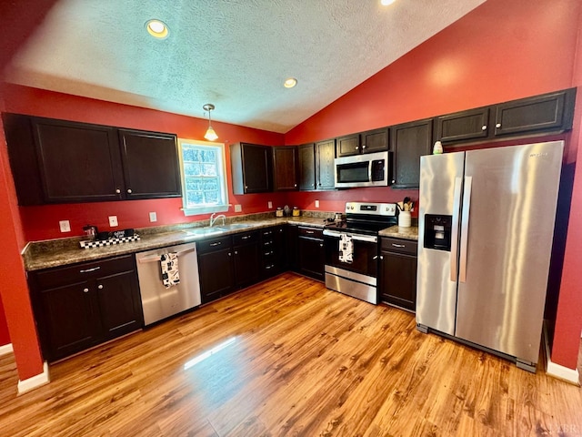 2809 Herbert St, Lynchburg, VA 24501 - kitchen featuring appliances with stainless steel finishes, a sink, lofted ceiling, a textured ceiling, and light wood-type flooring
