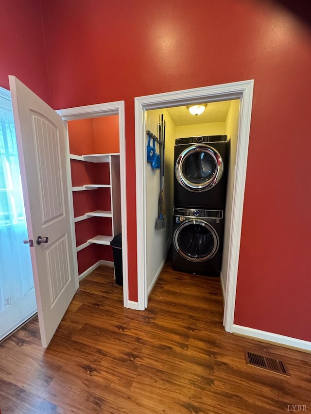 2809 Herbert St, Lynchburg, VA 24501 - laundry area with estacked washer and dryer, wood finished floors, and baseboards