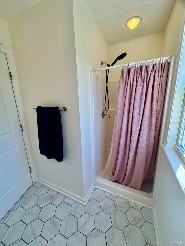 2809 Herbert St, Lynchburg, VA 24501 - bathroom featuring a textured ceiling, a stall shower, and baseboards