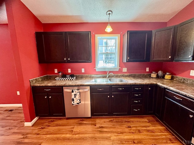 2809 Herbert St, Lynchburg, VA 24501 - kitchen featuring dishwasher, a sink, light wood-style floors, a textured ceiling, and dark countertops