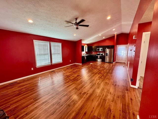 2809 Herbert St, Lynchburg, VA 24501 - unfurnished living room with vaulted ceiling, a ceiling fan, a textured ceiling, wood finished floors, and baseboards