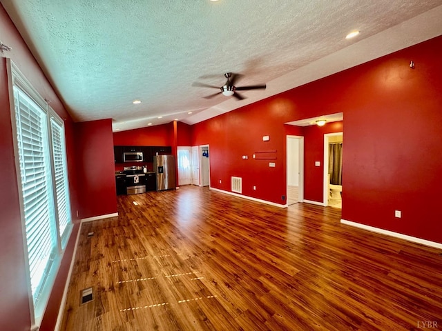 2809 Herbert St, Lynchburg, VA 24501 - unfurnished living room with lofted ceiling, a textured ceiling, wood finished floors, healthy amount of natural light, and baseboards