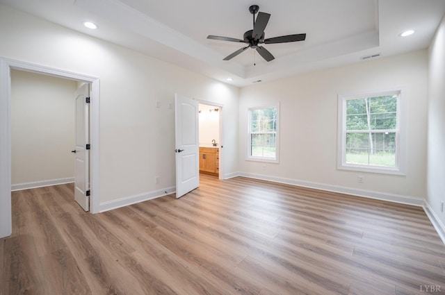 5 Live Oak Dr, Forest, VA 24551 - unfurnished bedroom with a tray ceiling, multiple windows, light wood-style floors, and recessed lighting