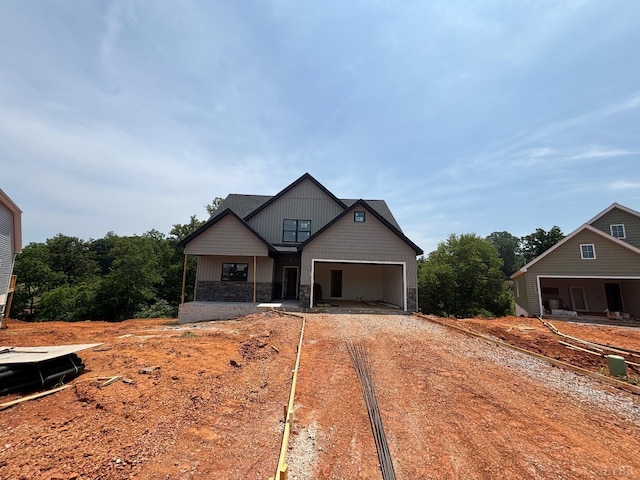 5 Live Oak Dr, Forest, VA 24551 - craftsman-style home with dirt driveway, stone siding, and a garage