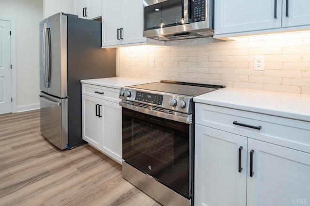 5 Live Oak Dr, Forest, VA 24551 - kitchen with appliances with stainless steel finishes, light wood finished floors, white cabinetry, and light countertops