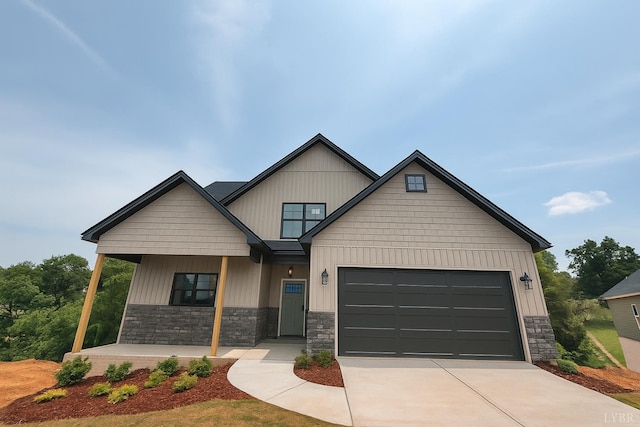 5 Live Oak Dr, Forest, VA 24551 - craftsman-style house featuring covered porch, stone siding, concrete driveway, and a garage